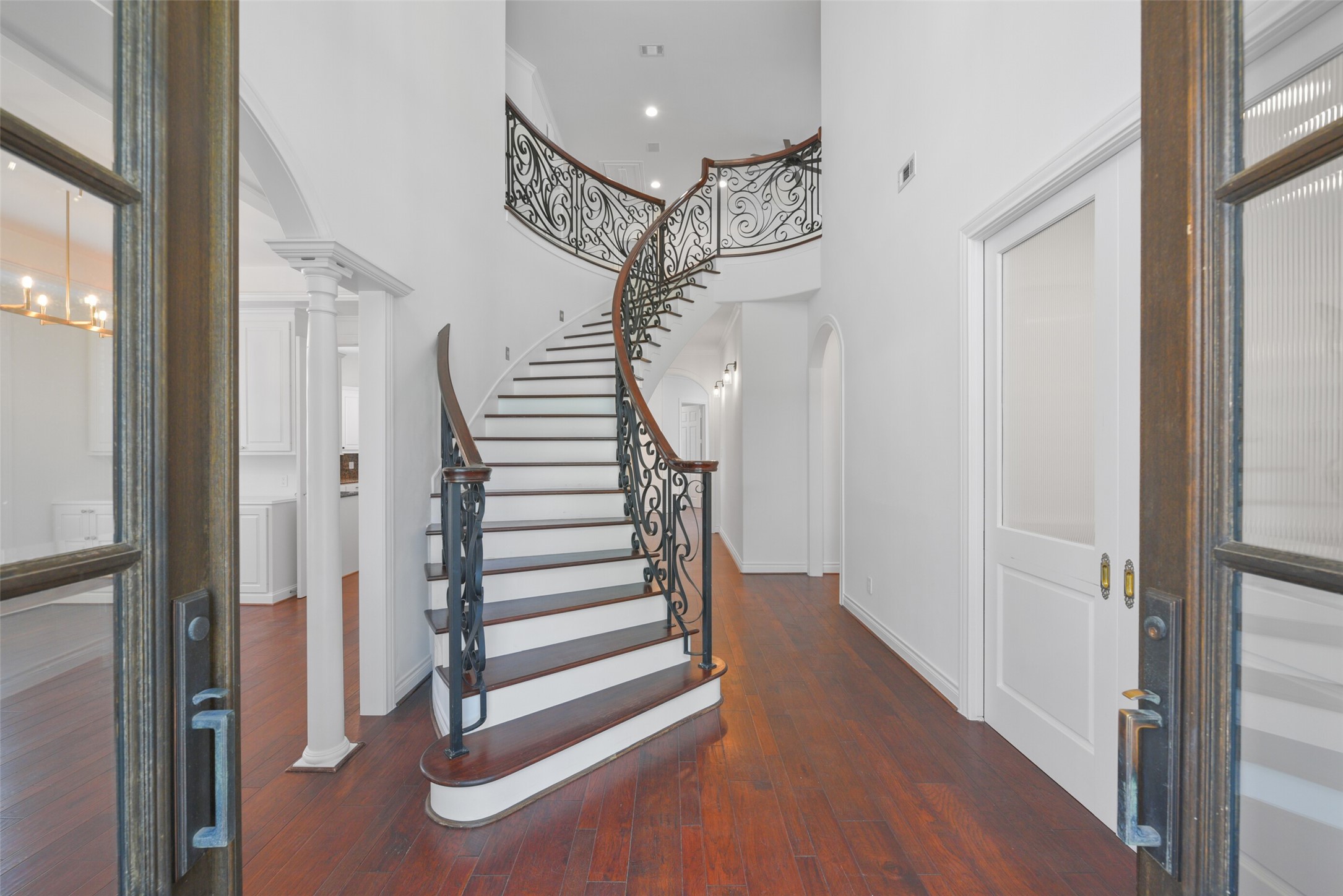 3724 Wroxton Road Houston, TX 77005 - Photo 4 of 40 The 2-story foyer sets the stage for this beautiful home. To the left is a large dining room. To the right, through the closed double doors, is a private, wood-paneled study.