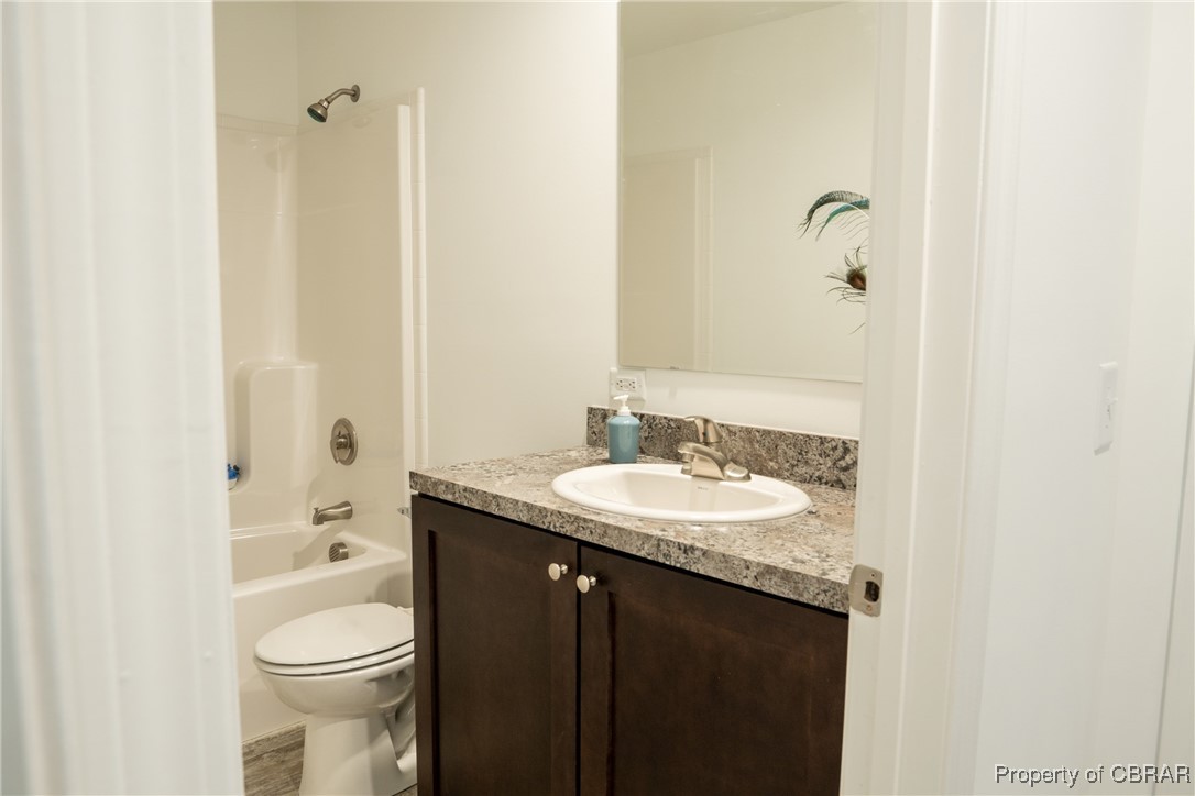 5726 Clay Bank Road Gloucester, VA 23061 - Photo 27 of 40 Full bathroom with shower / bathtub combination, toilet, vanity, and hardwood / wood-style floors