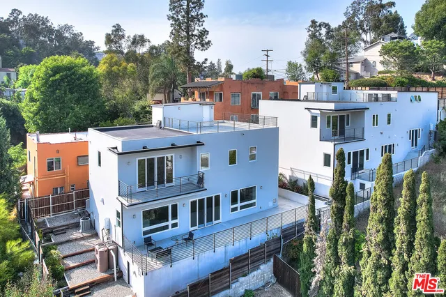 an aerial view of residential houses with outdoor space