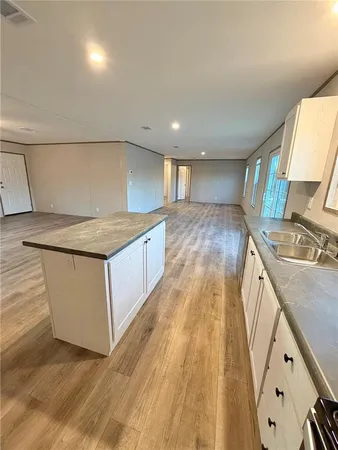 a view of a kitchen counter space with wooden floor