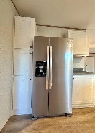 a view of refrigerator and wooden floor