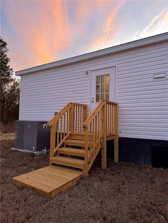 a view of a house with backyard and deck