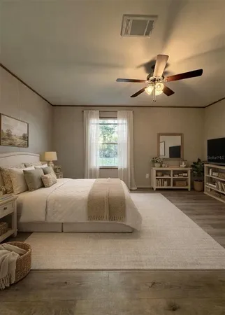 a bedroom with a large bed and a chandelier