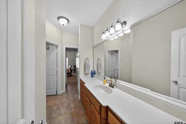 a bathroom with a double vanity sink and a mirror