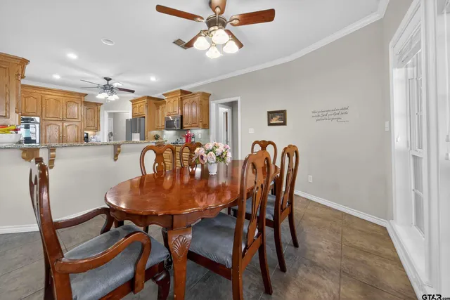 a dining room with furniture and window