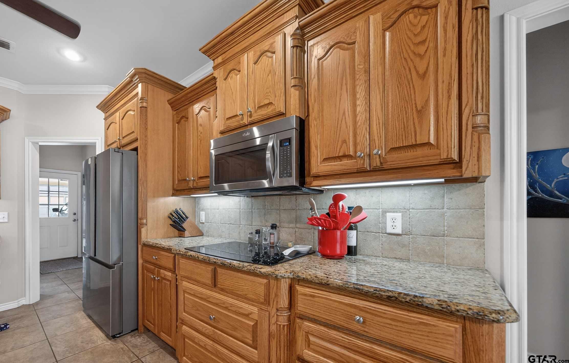 332 Highlander Heights Hideaway, TX 75771 - Photo 13 of 39 a kitchen with stainless steel appliances granite countertop a sink and cabinets