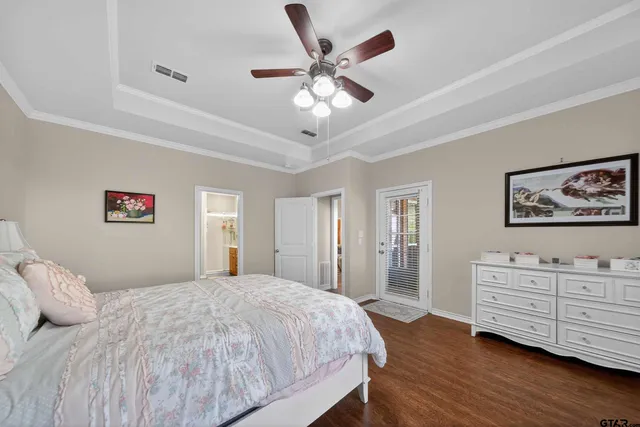 a bedroom with a large bed and a chandelier