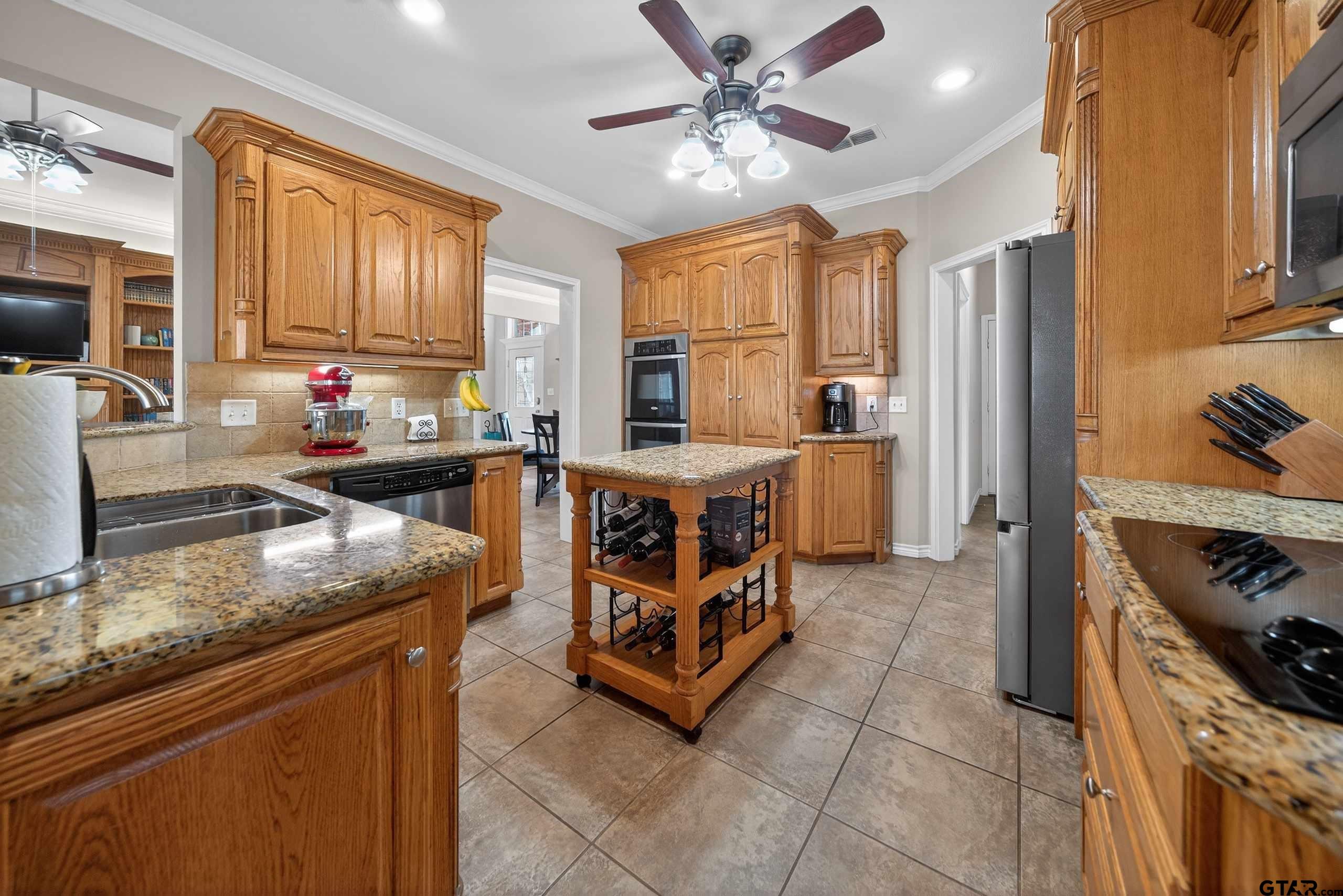 332 Highlander Heights Hideaway, TX 75771 - Photo 17 of 39 a kitchen with stainless steel appliances granite countertop a stove oven and a refrigerator