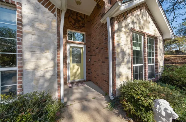 a view of a brick house with a large window