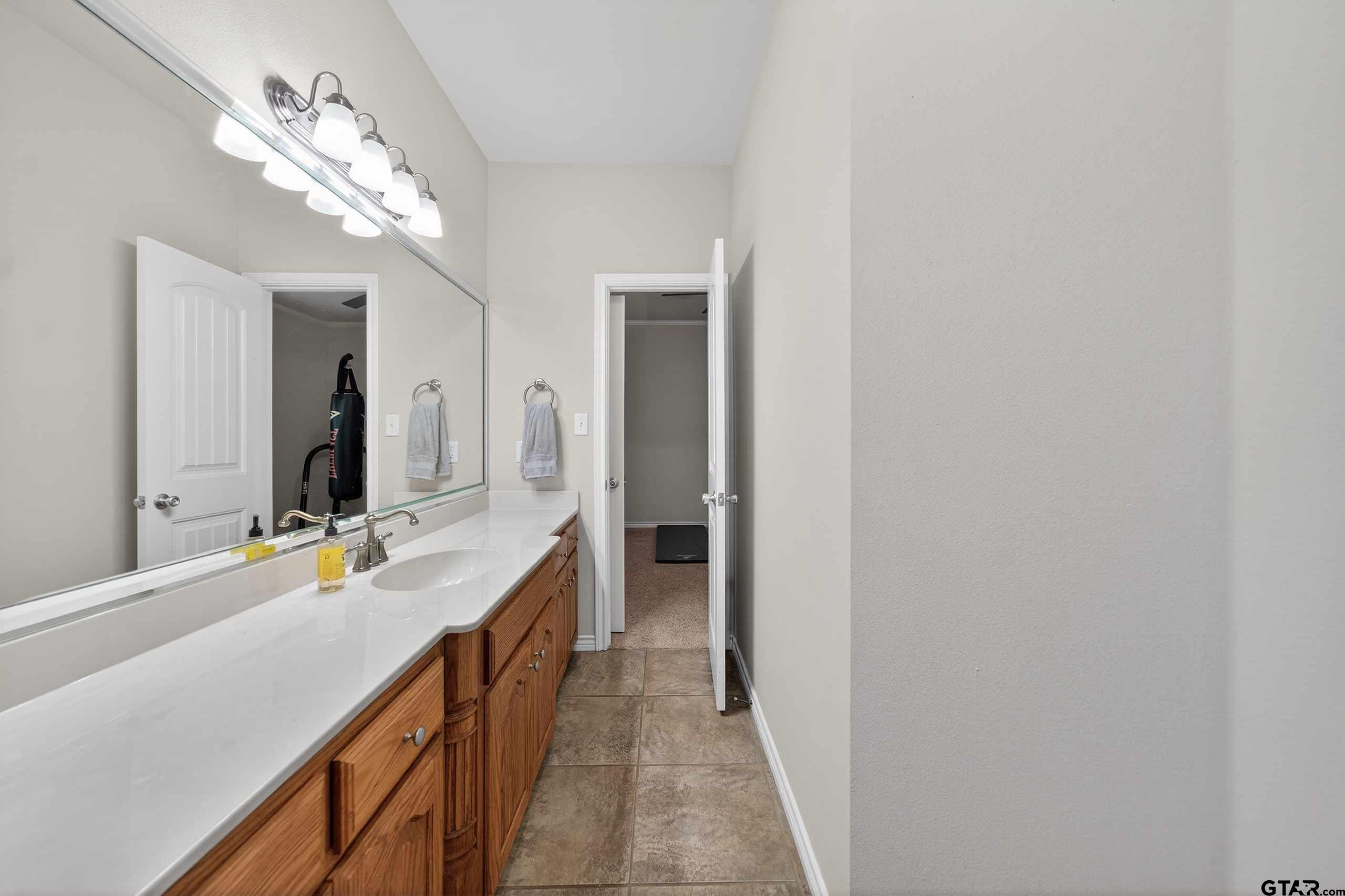 332 Highlander Heights Hideaway, TX 75771 - Photo 2 of 39 a bathroom with a double vanity sink and a mirror