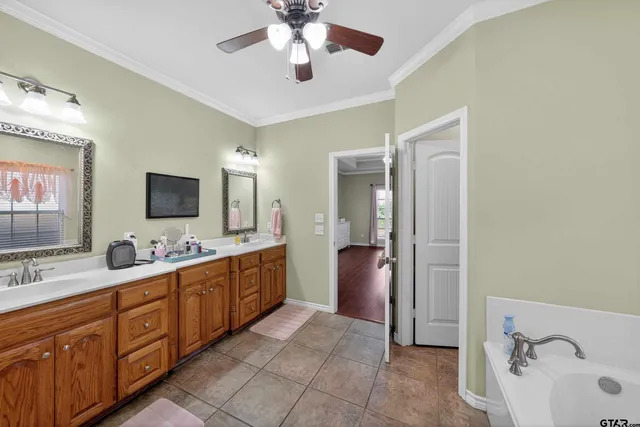 a large bathroom with a double vanity sink a mirror and shower