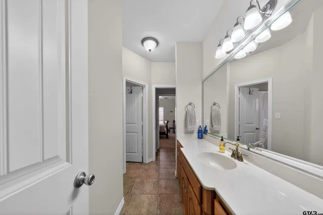 a bathroom with a sink a mirror and a shower
