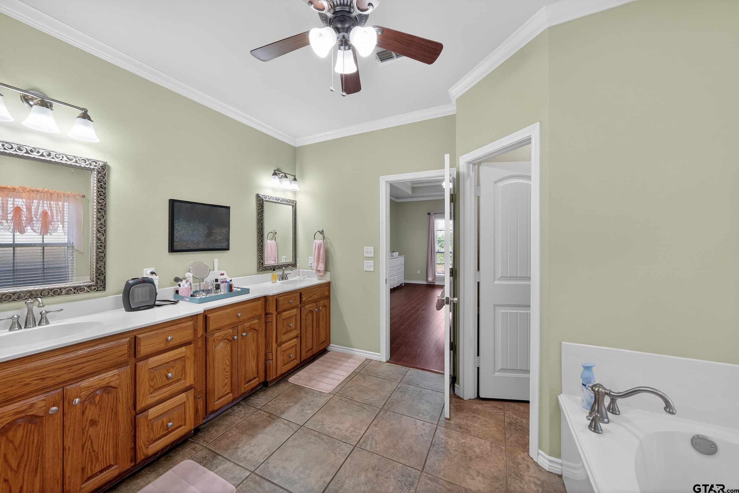 332 Highlander Heights Hideaway, TX 75771 - Photo 27 of 39 a large bathroom with a double vanity sink a mirror and shower