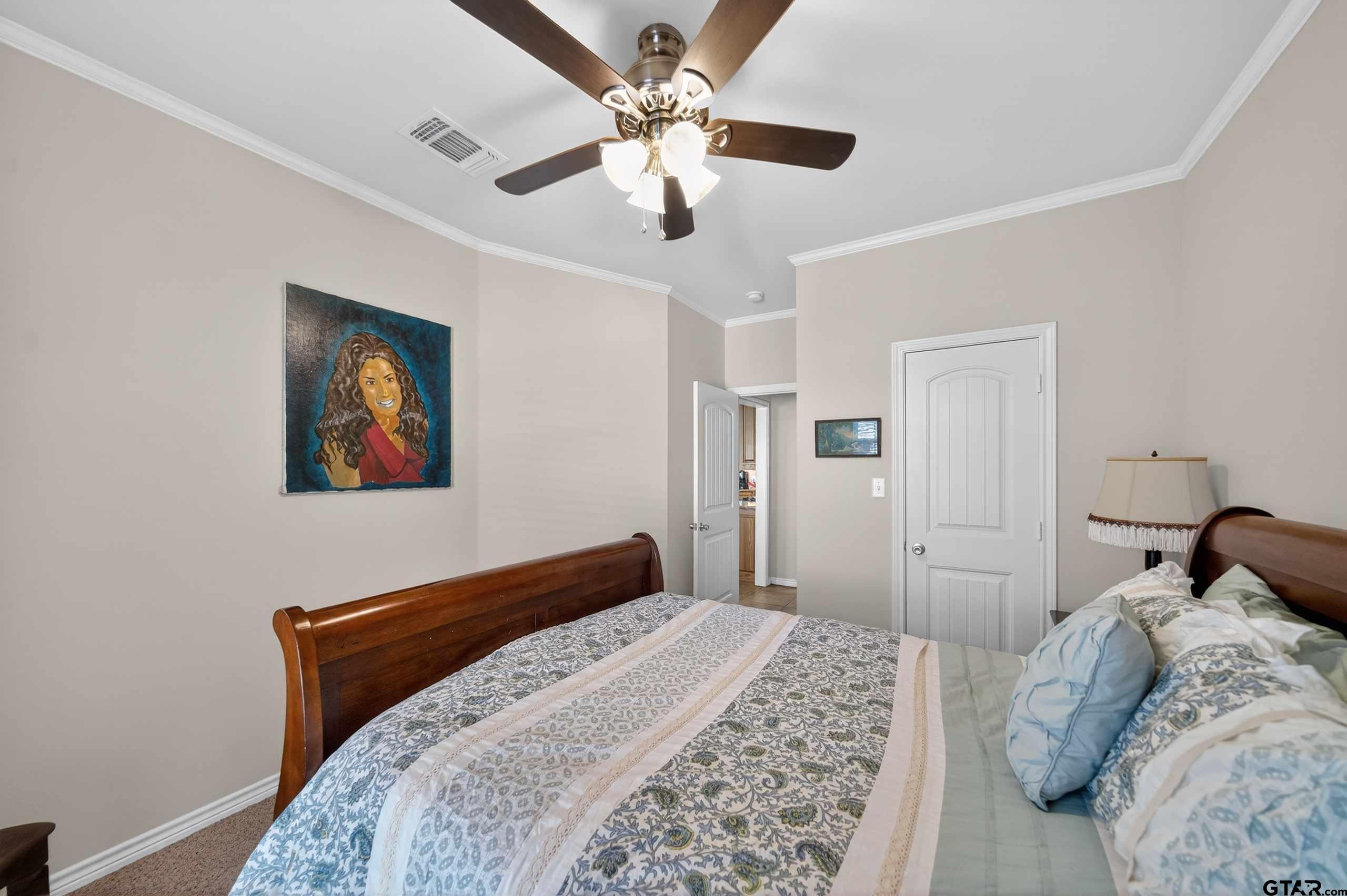 332 Highlander Heights Hideaway, TX 75771 - Photo 29 of 39 a bedroom with a large bed and a chandelier