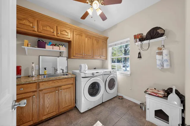 a utility room with sink dryer and washer