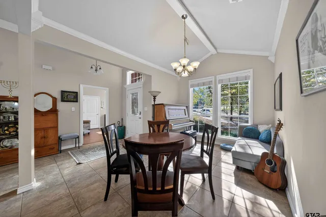 a view of a dining room with furniture and chandelier
