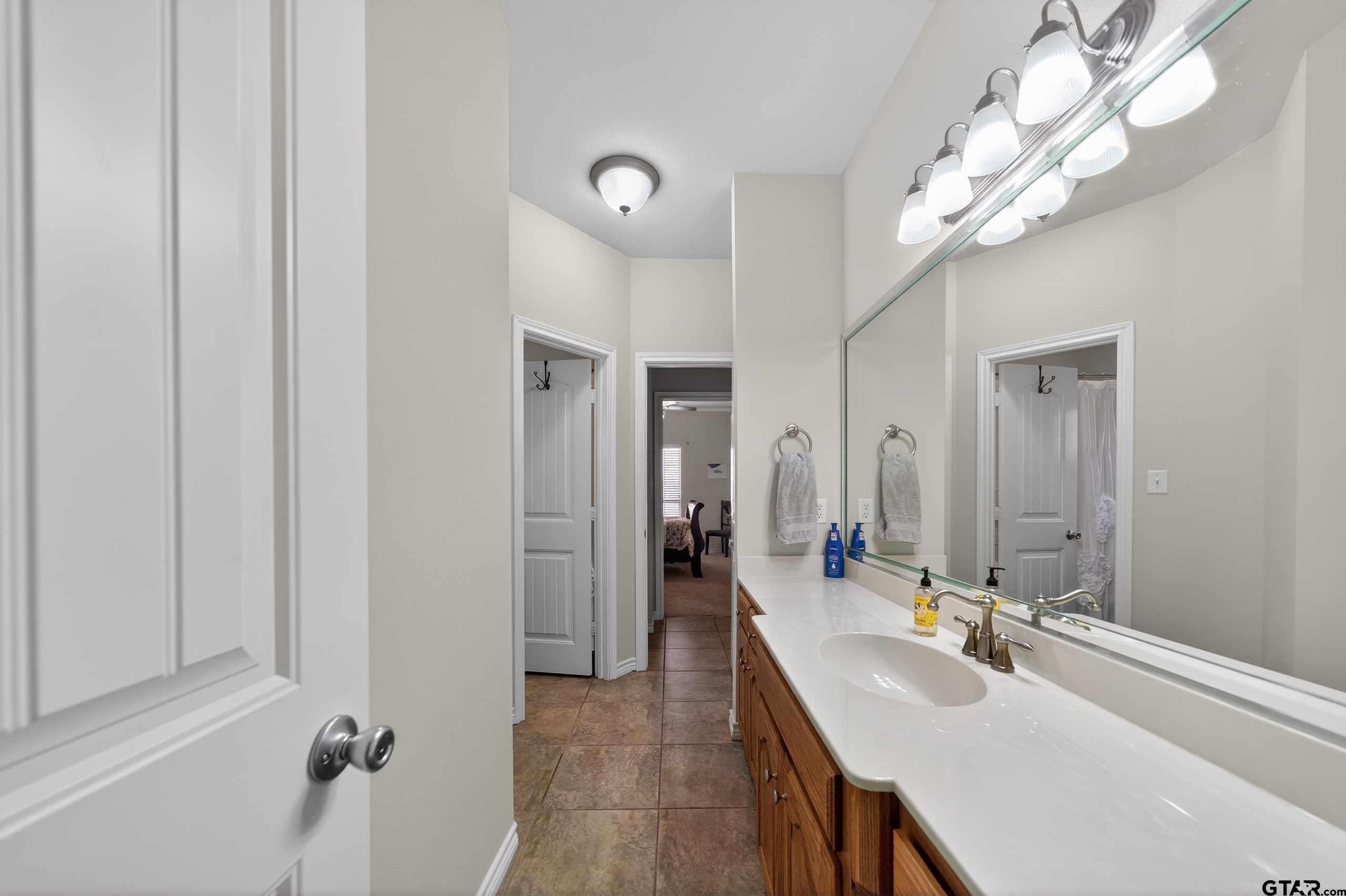 332 Highlander Heights Hideaway, TX 75771 - Photo 31 of 39 a bathroom with a sink a mirror and a shower