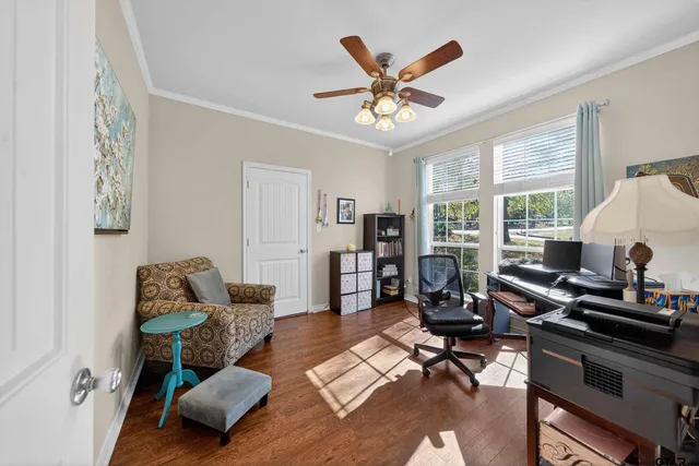 a living room with furniture and wooden floor
