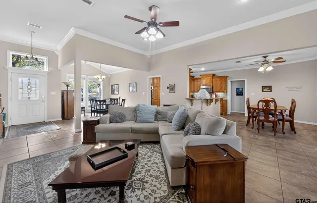a living room with furniture and wooden floor