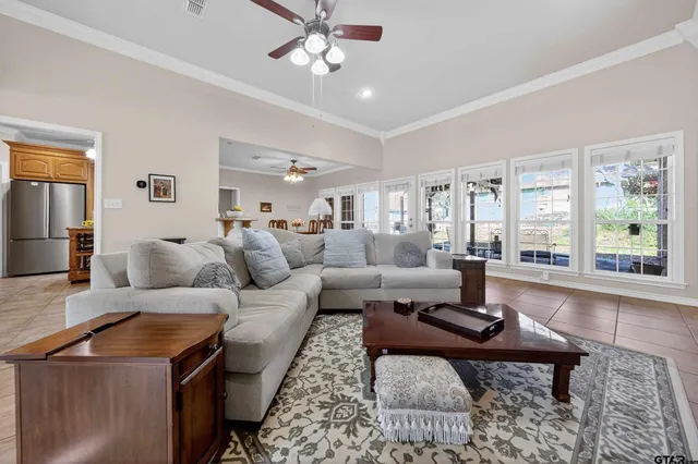 a living room with furniture a large window and a table