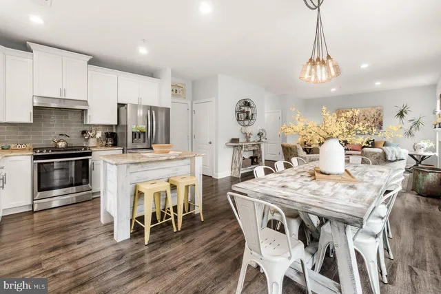 a view of a dining room with furniture kitchen and wooden floor