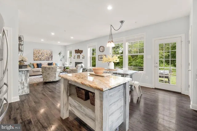 a kitchen with a stove and a view of living room