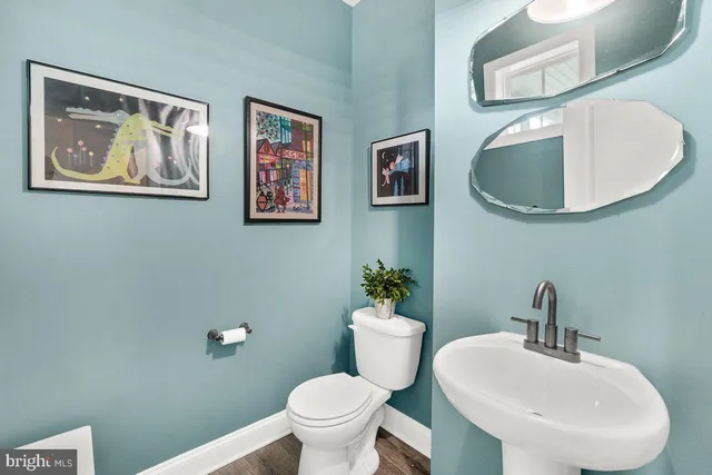 a bathroom with a toilet a sink and a mirror