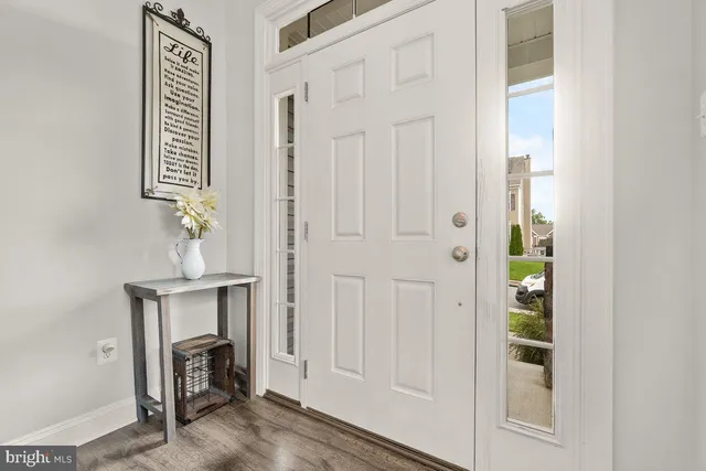 a view of an entryway with wooden floor