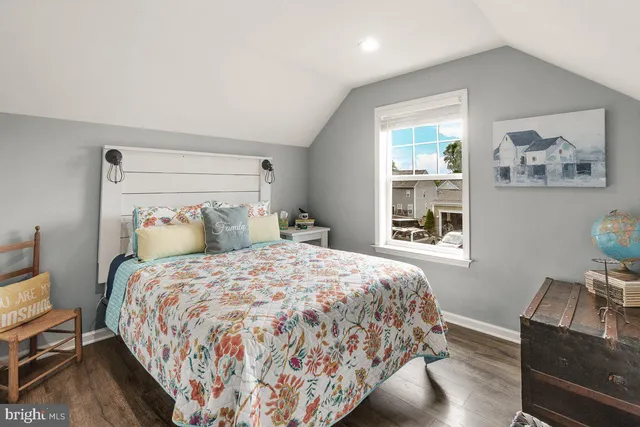 a bedroom with bed and wooden floor