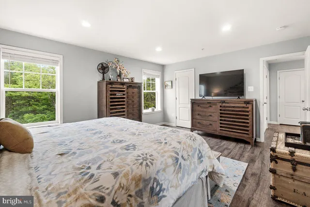 a bedroom with a bed and a flat screen television