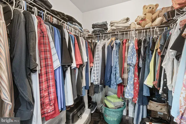 a view of walk in closet with clothes