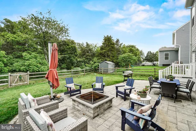 a view of a patio with couches chairs and a yard