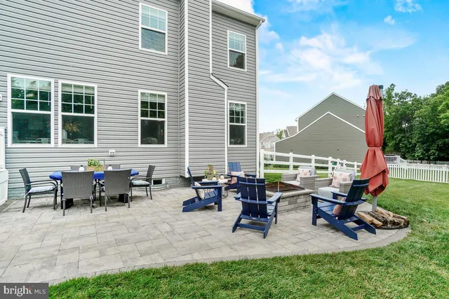 a view of a house with patio and a yard