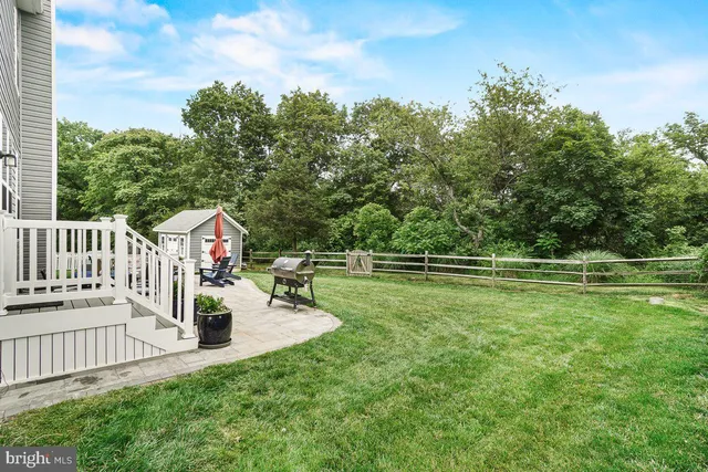 a view of a house with a yard and sitting area