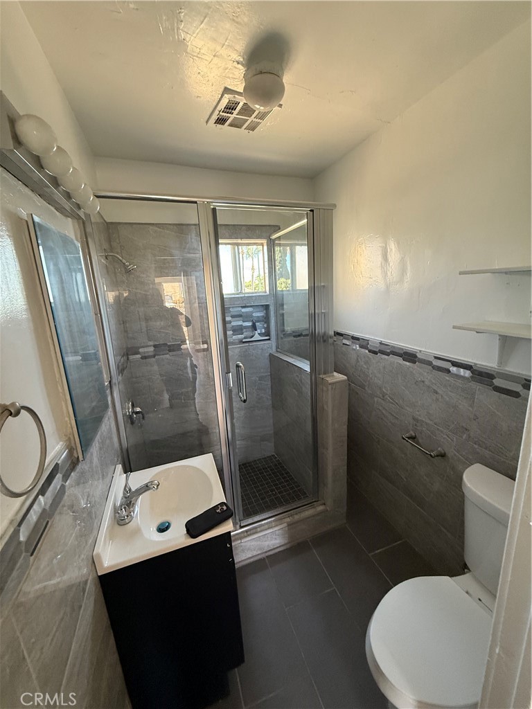 2853 East 6th Street, Unit 2 Los Angeles, CA 90023 - Photo 12 of 14 a bathroom with a sink a toilet and a shower