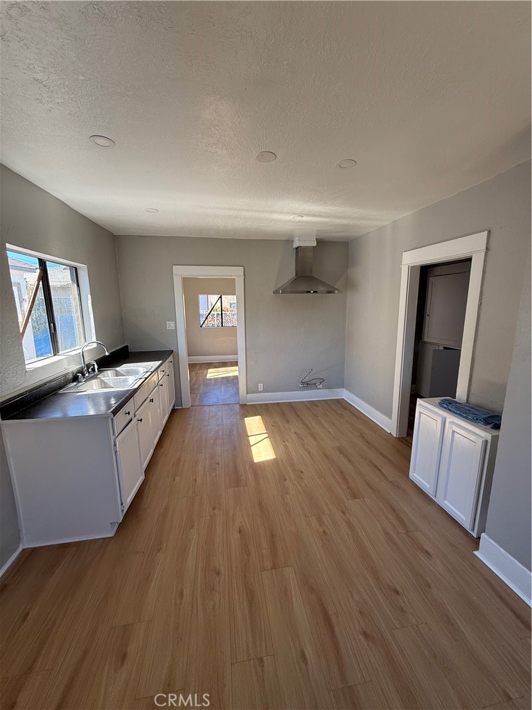 2853 East 6th Street, Unit 2 Los Angeles, CA 90023 - Photo 14 of 14 a kitchen with granite countertop a stove and wooden floor