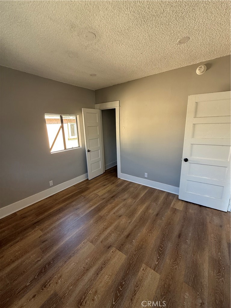 2853 East 6th Street, Unit 2 Los Angeles, CA 90023 - Photo 2 of 14 an empty room with wooden floor and windows