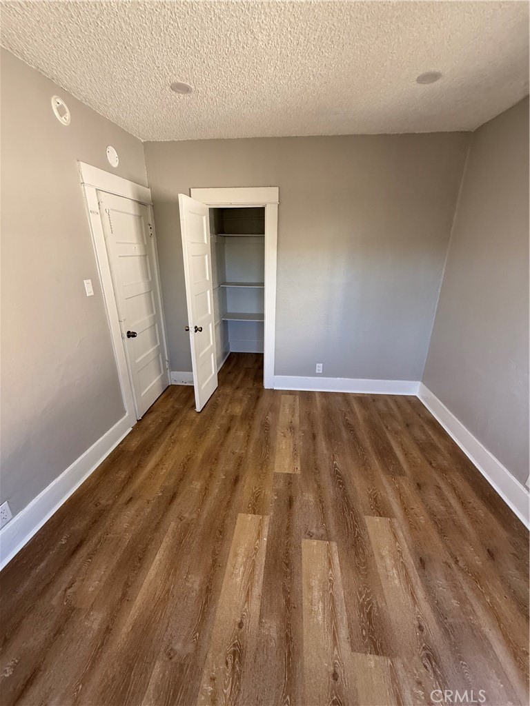 2853 East 6th Street, Unit 2 Los Angeles, CA 90023 - Photo 5 of 14 a view of a room with wooden floor and white walls