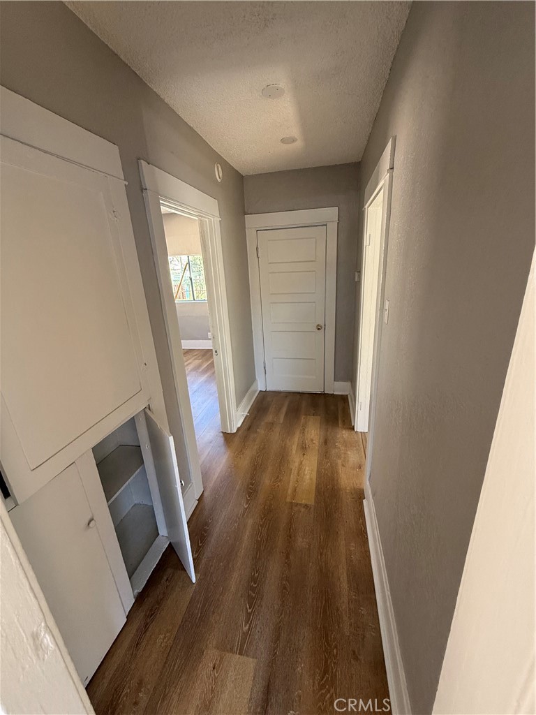 2853 East 6th Street, Unit 2 Los Angeles, CA 90023 - Photo 7 of 14 a view of front door with wooden floor and stairs