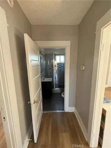 a view of a hallway view with wooden floor and staircase
