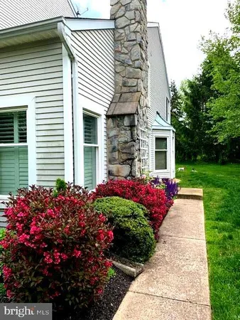 a front view of a house and a garden