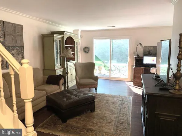 a living room with furniture and flat screen tv