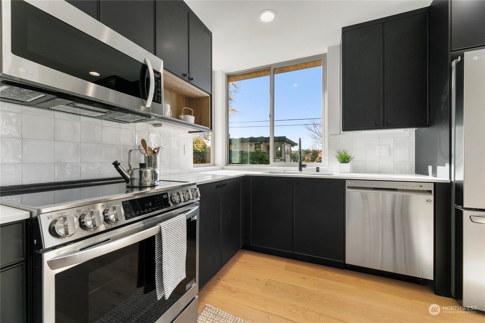 3617 South Hanford Street Seattle, WA 98144 - Photo 7 of 32 a kitchen with stainless steel appliances a stove a sink and a microwave