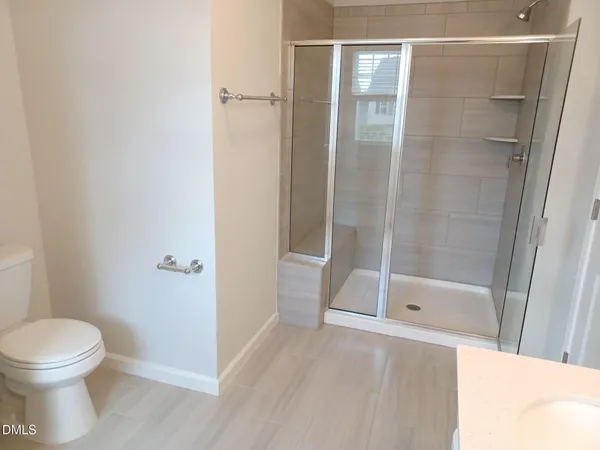 a bathroom with a shower and a toilet