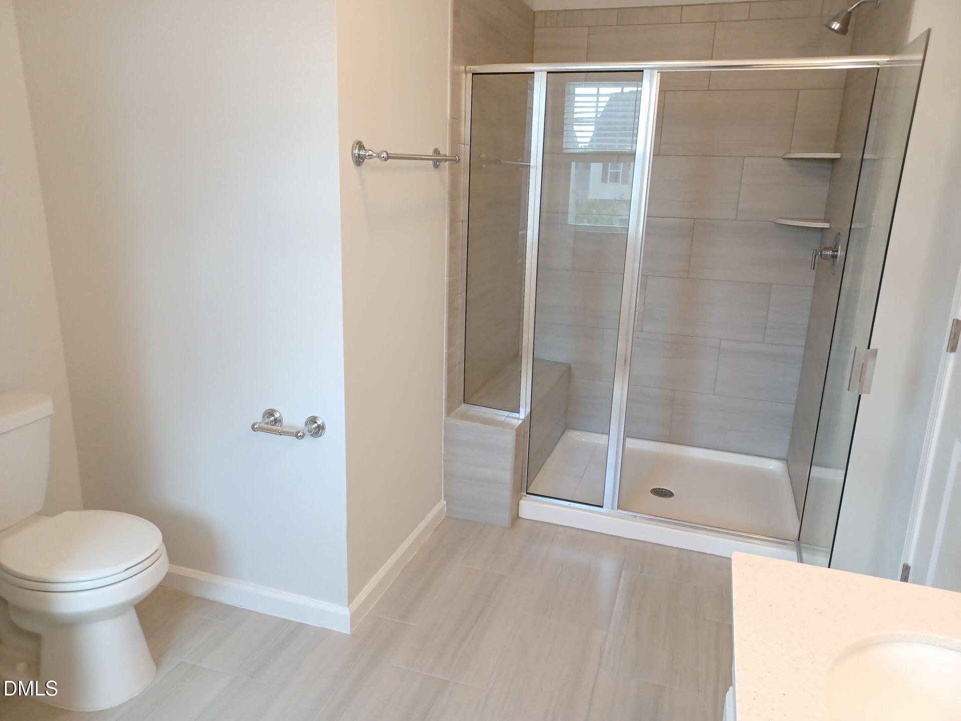 6079 Beale Loop Raleigh, NC 27616 - Photo 14 of 22 a bathroom with a shower and a toilet