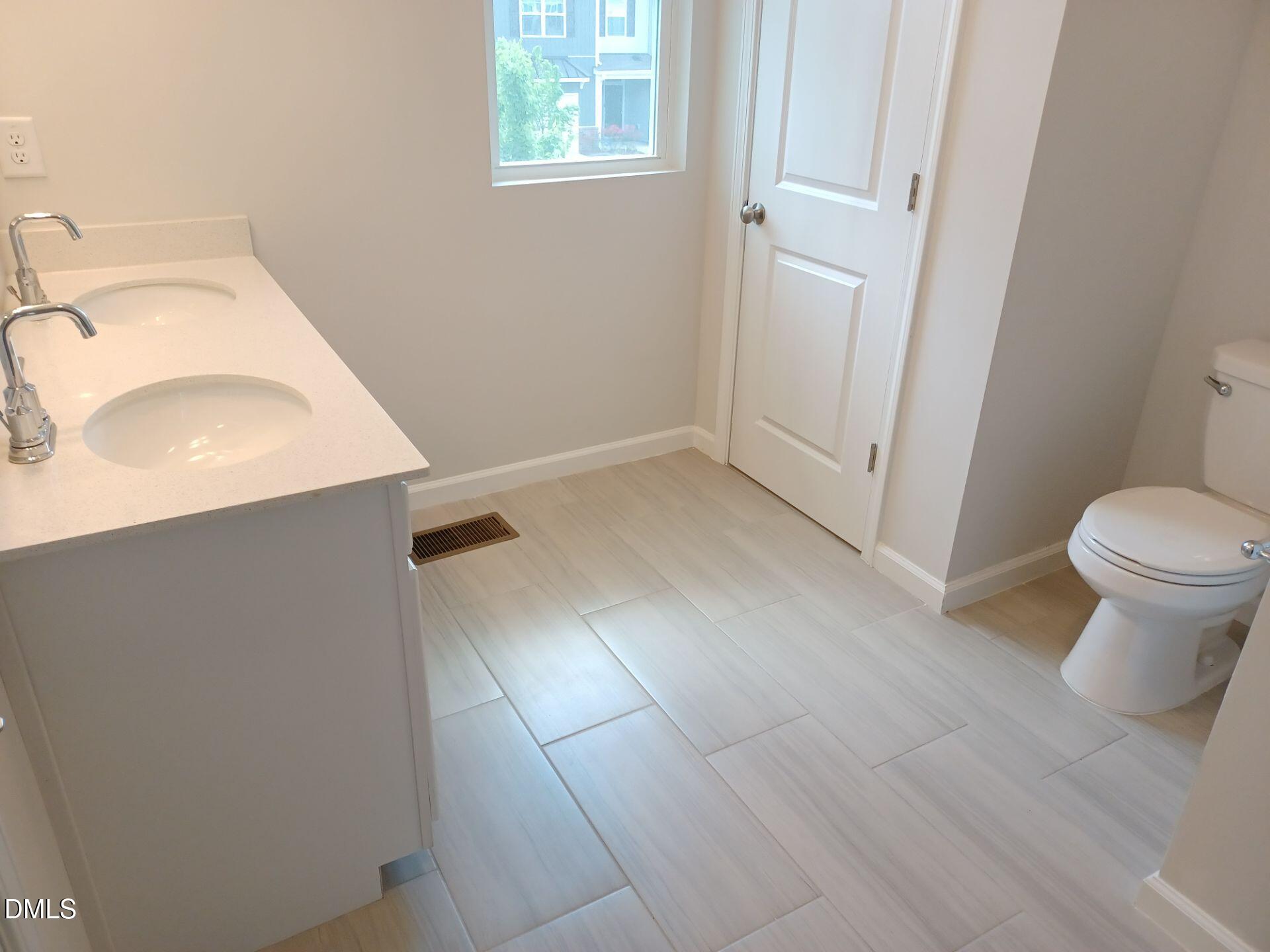 6079 Beale Loop Raleigh, NC 27616 - Photo 18 of 22 a bathroom with a sink and a toilet