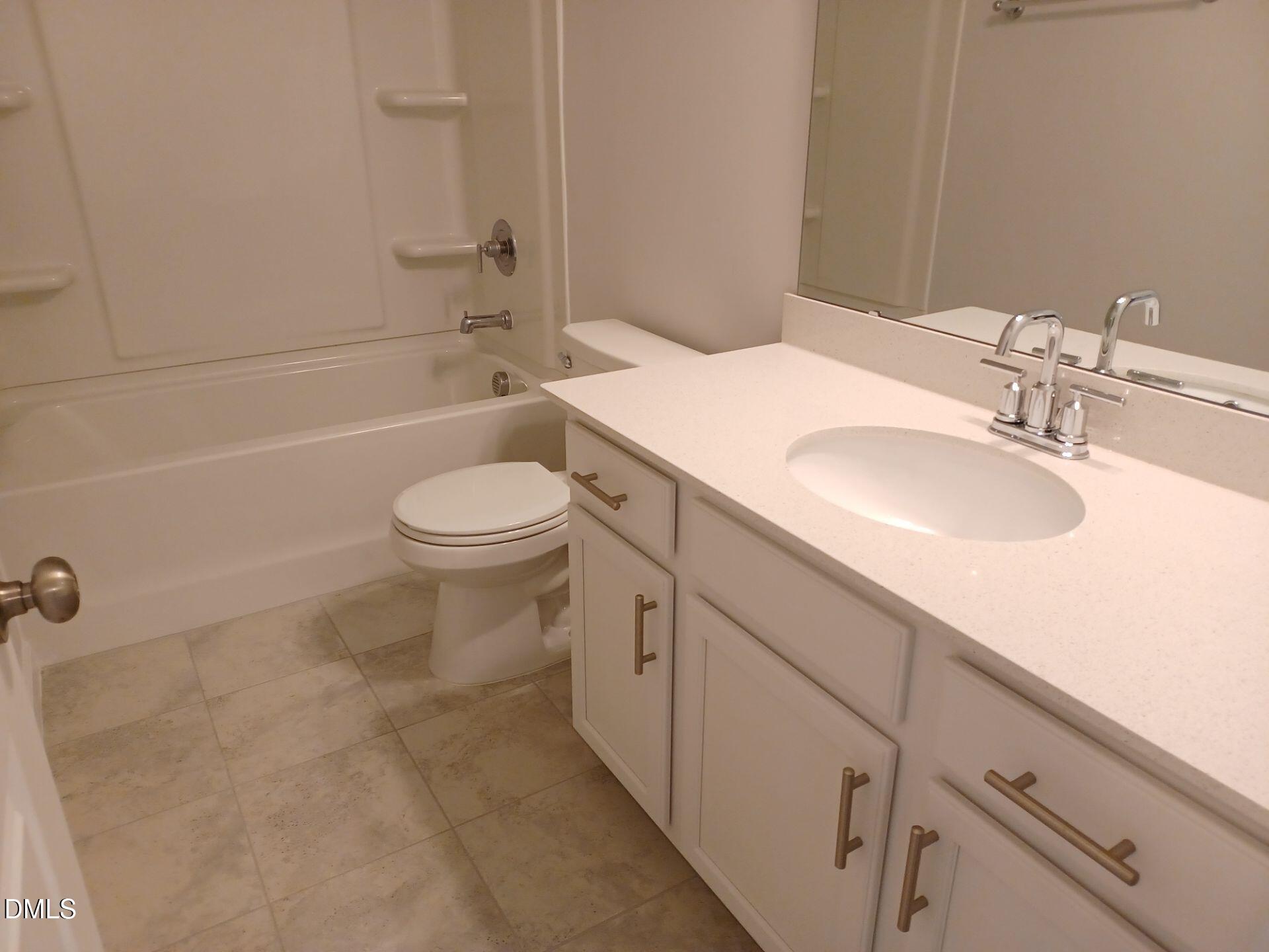 6079 Beale Loop Raleigh, NC 27616 - Photo 19 of 22 a bathroom with a sink a toilet and shower