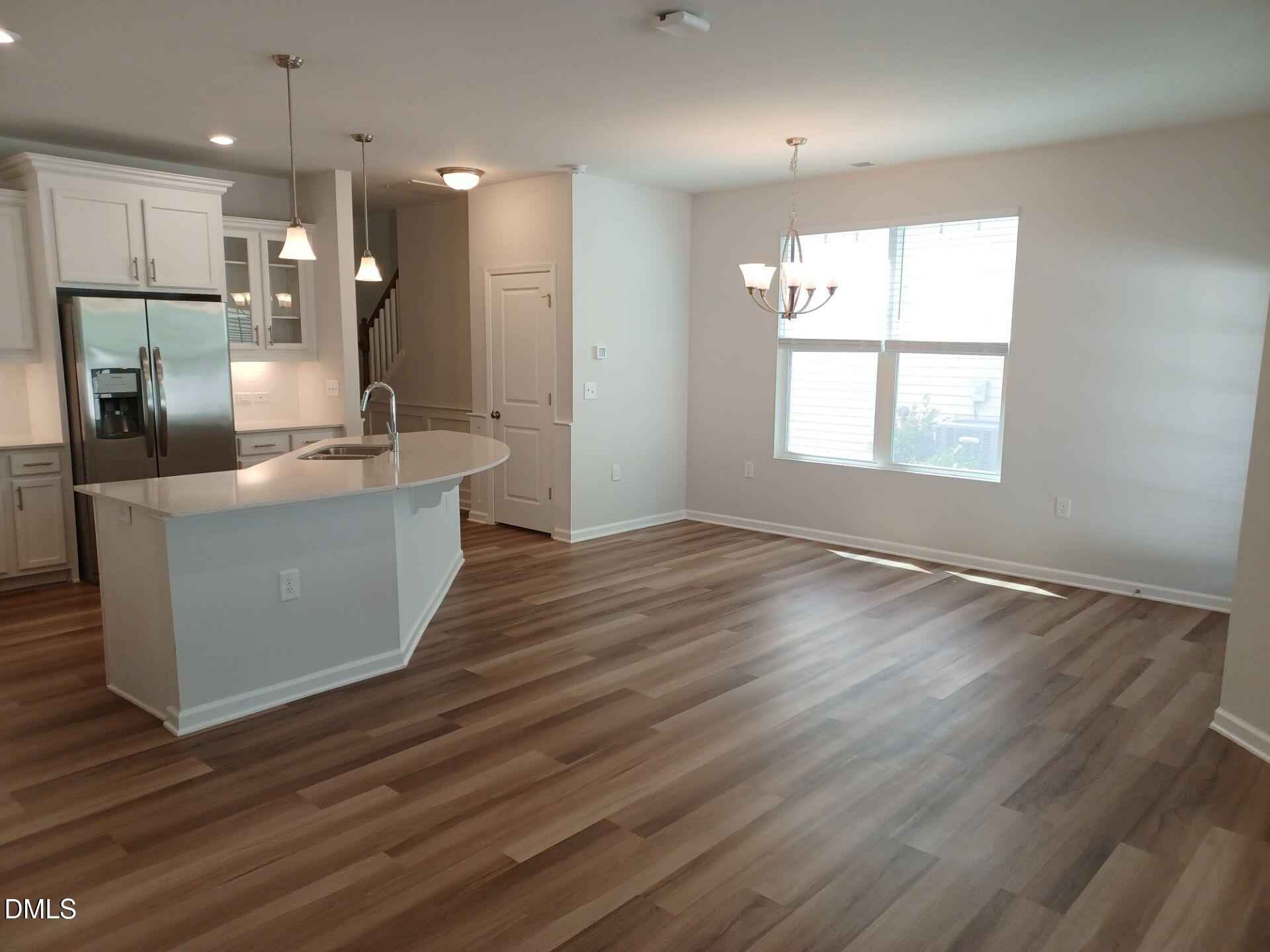 6079 Beale Loop Raleigh, NC 27616 - Photo 4 of 22 an open kitchen with a sink and dish washer