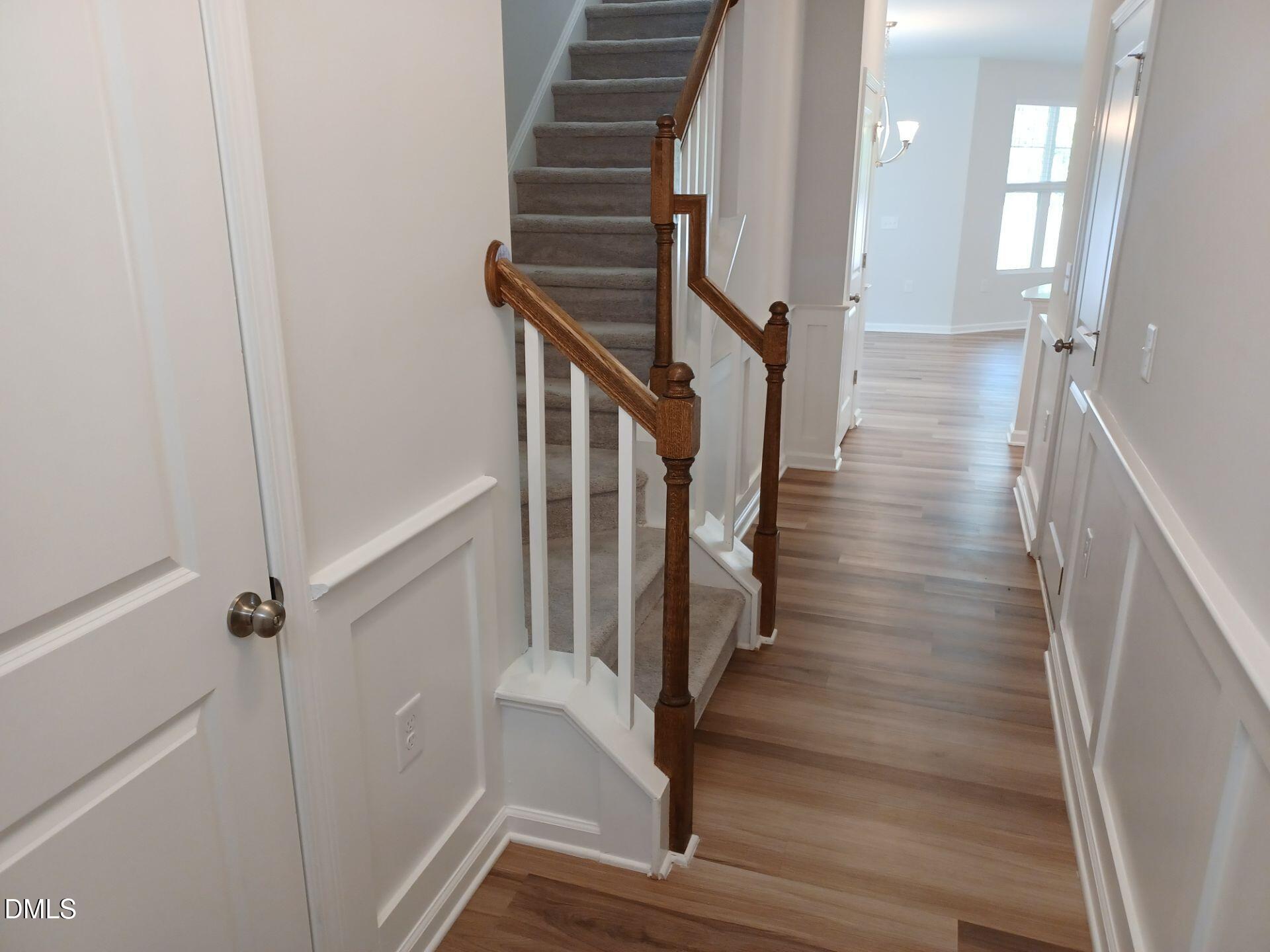 6079 Beale Loop Raleigh, NC 27616 - Photo 6 of 22 a view of entryway and gallery with wooden floor