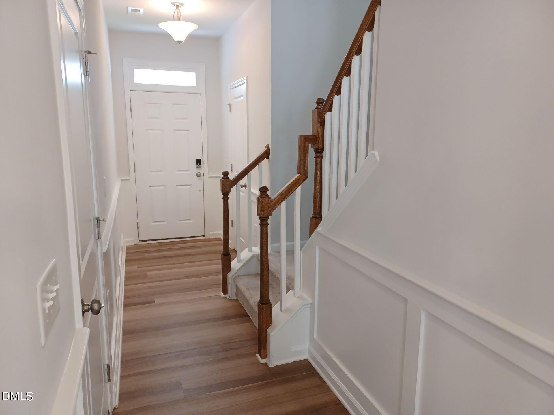 6079 Beale Loop Raleigh, NC 27616 - Photo 7 of 22 a view of entryway with wooden floor